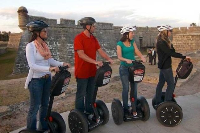 a group of people standing in a parking lot