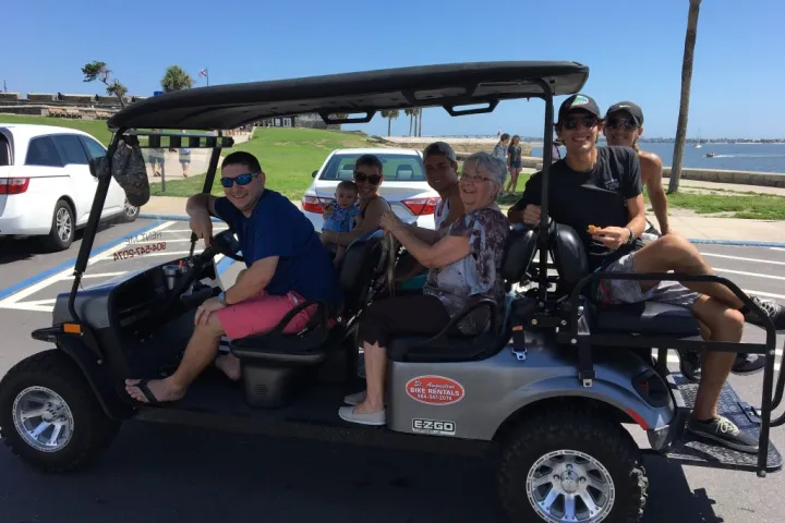 a group of people riding on the back of a truck