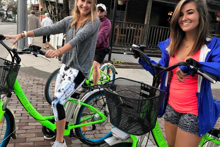 a woman holding a bicycle