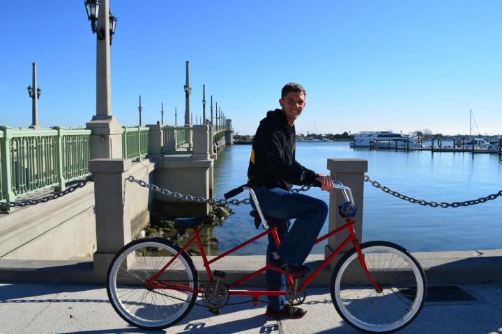 a man riding on the back of a bicycle